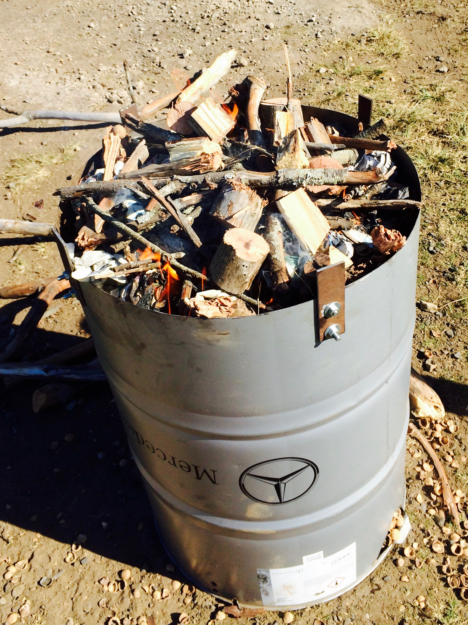 A 210 L steel drum with the top cut off and flanges fabricated to hold the lid just elevated. The drum had air holes drilled along the bottom to allow for air flow through the burn. Wood was packed as tightly as possible around the inner retort drum and lit on the top.